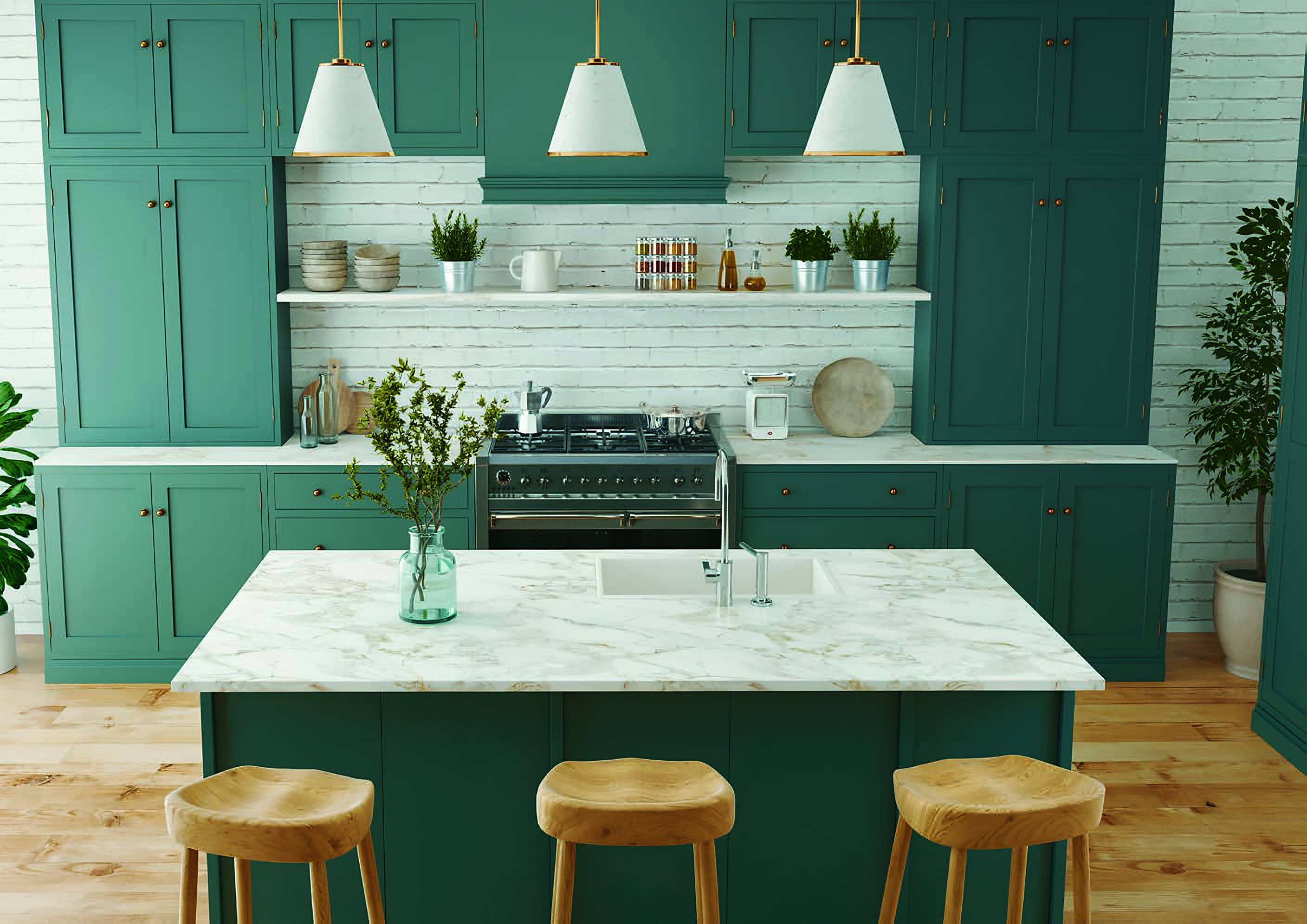 In-frame kitchen in deep teal against white-painted brick, with brass pendant lights, a range cooker and a marble-effect island with three wooden stools.
